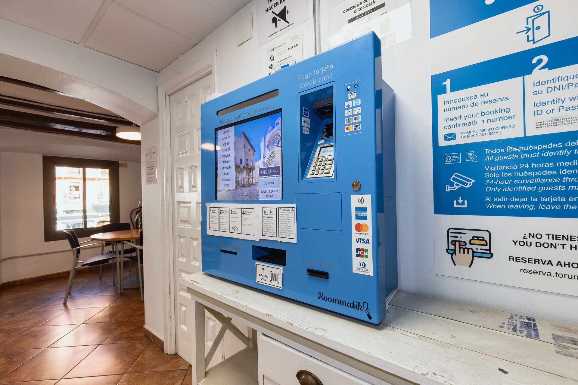 Máquina de auto check-in en la recepción del hostal.